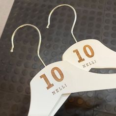 two white hangers with the numbers ten and ten on them