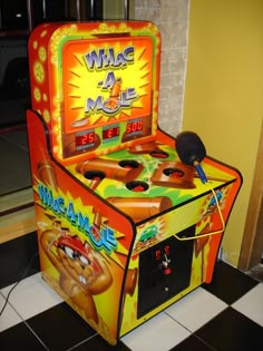 an arcade game machine sitting on top of a black and white checkered floor