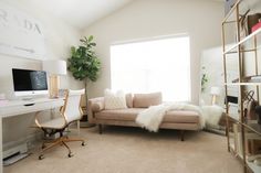 a living room filled with furniture and a computer desk