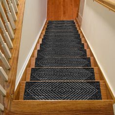 the stairs are made of wood and have purple rugs on them