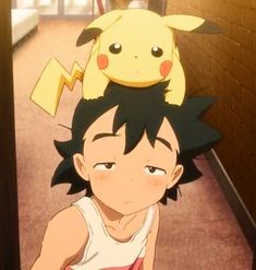 an anime character with a pikachu on top of his head in the hallway