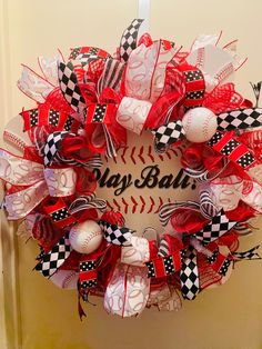 a wreath with baseballs and checkered ribbon on it that says, happy ball