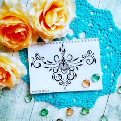 a blue doily with some flowers and beads on it