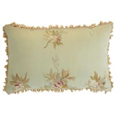 an embroidered pillow with flowers on it