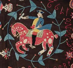 an embroidered cloth with a man on a horse