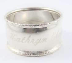 an antique sterling silver wedding band with the word bathory engraved on it's side