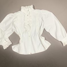 White gorgeous blouse made of cotton, mutton sleeves and embroidered collar.   Very good condition.  It has a chic  style. Measurements Shoulders  44 CM Bust 134 cm Sleeve length 64 cm Length 67 cm Everything is measured flat. last button down missing Vintage White Shirt For Fall, Elegant Vintage White Cotton Tops, Elegant White Shirt With Broderie Anglaise, Elegant Cotton Shirt With Lace Collar, Classic White Blouse With Bishop Sleeves, Classic White Blouse With Broderie Anglaise, Classic White Broderie Anglaise Blouse, White Cottagecore Blouse For Fall, Classic Vintage White Blouse For Daywear