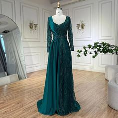 a dress on display in a room with white walls and wooden floors, including a mannequin