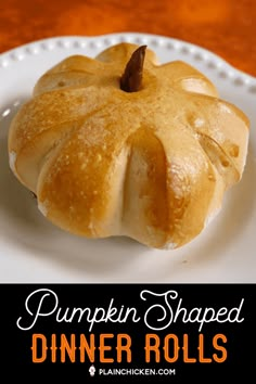 a pumpkin shaped dinner roll on a plate with the words pumpkin shaped dinner rolls above it