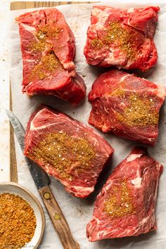 raw steaks with spices and seasoning on top