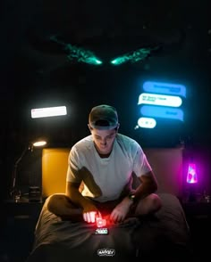 a man sitting on top of a bed in the dark