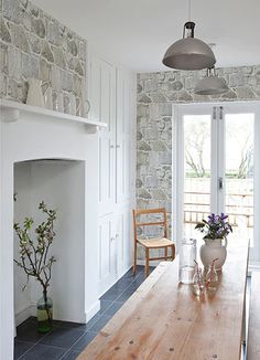 a wooden table sitting in front of a fireplace