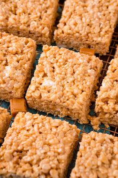 several squares of rice krispy treats sitting on a cooling rack, ready to be eaten