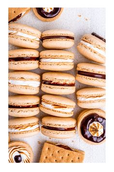 an assortment of cookies and pastries on a white surface with chocolate sauce in the middle