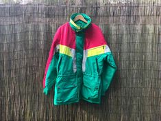 "Vintage Swedish men snow jacket with lots of pockets and adjustable waist. Bright colours, green, pink and yellow. Size - vintage men size 52 Measured flat- Shoulder seam to shoulder seam 58cm ( 23\") Underarm to underarm 65cm (25.5\") Sleeve length, from shoulder to edge 62cm ( 24.5\") Length 82cm (32\") It is in excellent vintage condition, looks like unused. Real colors may be little different from their appearance on your display. Pleas look at the pictures carefully. I will be happy to ans Vintage Pink Outerwear For Outdoor, Winter Multicolor Outerwear For Hiking, Retro Green Outerwear For Outdoors, Green Windbreaker For Cold Weather, Retro Green Outerwear For Outdoor, Retro Green Outdoor Outerwear, Hooded Green Skiing Outerwear, Green Hooded Skiing Outerwear, Green Winter Windbreaker For Hiking