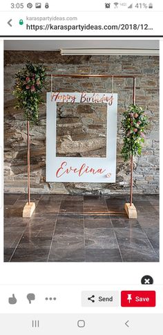 an image of a happy birthday sign with flowers on the front and side, along with two candles