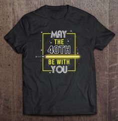 star wars may the 4th be with you t - shirt on a wooden table top