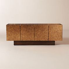 the sideboard is made out of wood and has three doors