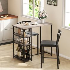 a kitchen table with two chairs next to it and a wine rack on the side