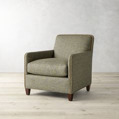 a chair sitting on top of a hard wood floor next to a white wall and wooden floors