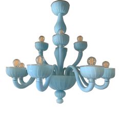 a blue chandelier with six lights hanging from it