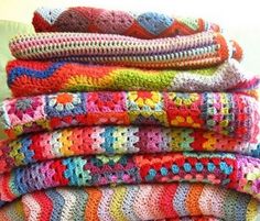 a stack of crocheted blankets sitting on top of each other