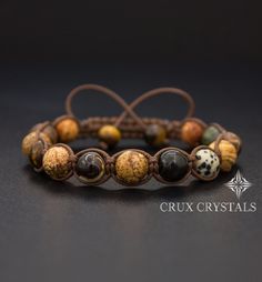 Handcrafted Men's Natural Stone Shamballa Bracelet made of 10mm mixed natural stone beads - Picture Jasper, Dalmatian Jasper, Yellow Tiger's Eye, Gold Obsidian, Brown Retro Agate, Russian Serpentine, and Coffee Mother of Pearl, all combined with dark brown shamballa waxed cord. The item ends with two Yellow Tiger's Eye beads as stoppers. Note: All men's bracelets can be made in a smaller women's size Just leave us a note with the order. Adjustable bracelet. For best results, please leave your wr Adjustable Agate Beaded Bracelets With Round Beads, Spiritual Macrame Braided Bracelets With Round Beads, Spiritual Macrame Braided Bracelets, Adjustable Agate Crystal Bracelet With Round Beads, Spiritual Macrame Jewelry With Round Beads, Spiritual Brown Braided Bracelets With Natural Stones, Spiritual Macrame Friendship Bracelets With Round Beads, Spiritual Braided Bracelets With Round Natural Stones, Adjustable Agate Crystal Bracelet With 8mm Beads