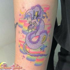 a colorful dragon tattoo on the right arm and leg, with rainbows in the background