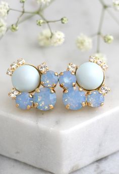 "Blue Earrings, Blue Sky Earrings, Bridal Powder Blue Earrings, Blue Opal Earrings, Cornflower Stud Earrings, Bridesmaids Blue Earrings Dazzling post Rose Gold Crystal earrings feature a round cut Swarovski Pearls set on a secure prong settings. The perfect shade for cocktail parties or to add a touch of color to your wedding ensemble Petite Delights is an Official SWAROVSKI® Branding Partner Our brand is legally licensed & authorized By Swarovski Company for high quality manufacturing. Deta Blue Clip-on Earrings For Wedding, Blue Drop Cluster Earrings For Gift, Blue Cluster Drop Earrings As Gift, Blue Ear Wire Earrings For Wedding, Blue Clip-on Earrings For Anniversary, Blue Cluster Earrings For Wedding, Blue Cluster Drop Earrings For Pierced Ears, Blue Round Cluster Earrings For Wedding, Bridesmaids Blue