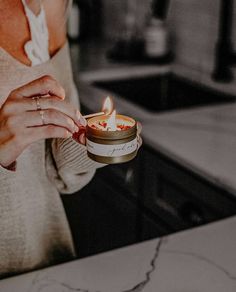 a woman holding a candle in her hand