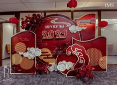 a red and gold new year's card display in an office building with chinese decorations