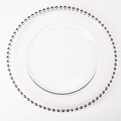 a white plate topped with lots of silver beads