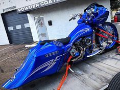 a blue motorcycle parked on the back of a truck