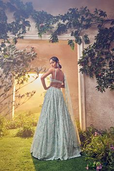 Featuring a mint green tulle lehenga embroidered fully by hand with various ornamental lustre sequences and Japanese bugle beads. It is paired with a scallop dupatta with crystal drops and blouse.From Aneesh Agarwaal's Ellora collection.DELIVERY TIMEPlease allow 8-12 weeks for your outfit to arrive.FABRIC DETAILSNetProfessional cleaning only. Green Organza Lehenga With Sequins, Pista Green Lehenga With Sequins For Wedding, Pista Green Sequined Anarkali Set For Wedding, Embellished Green Organza Lehenga, Elegant Pista Green Lehenga With Sequins, Elegant Pista Green Sequined Lehenga, Embellished Pista Green Wedding Gown, Green Anarkali Gown With Sequins, Green Sequined Gown For Reception