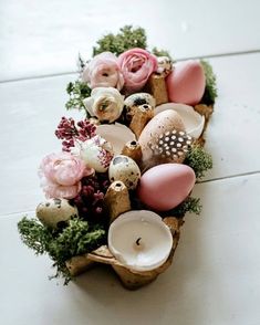 a vase filled with flowers and candles on top of a table