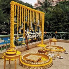 an outdoor wedding setup with yellow flowers and decorations