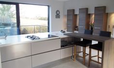 a modern kitchen with an island counter and stools