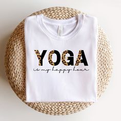 Yoga is my Happy Hour, Yoga Tshirt, Yoga Lover Shirt, Yoga Instructor Gift, Funny Yoga Tee, Fitness Shirt, Yoga Lover Gift, Workout Tee This classic unisex jersey short sleeve tee fits like a well-loved favorite. Soft cotton and quality print make users fall in love with it over and over again. These t-shirts have-ribbed knit collars to bolster shaping. The shoulders have taping for better fit over time. Dual side seams hold the garment's shape for longer. - 100% Airlume combed and ringspun cott Sporty Yoga T-shirt With Letter Print, Sporty Letter Print Tops For Yoga, Yoga Tops With Letter Print And Crew Neck, Sporty Letter Print T-shirt For Yoga, Crew Neck Yoga Tops With Letter Print, White Graphic Print T-shirt For Yoga, Cotton Activewear With Letter Print For Yoga, Cotton Letter Print Activewear For Yoga, Yoga Tee Shirt