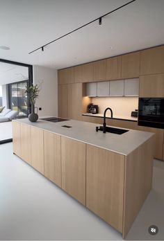 a modern kitchen with an island and sink