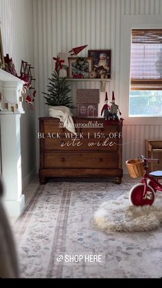 a living room with a christmas tree in the corner and a bike on the floor