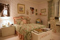 a bed room with a neatly made bed and pictures on the wall