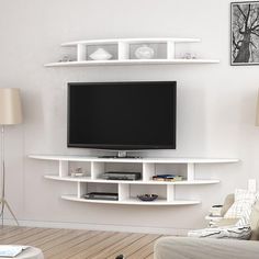 a flat screen tv sitting on top of a white shelf