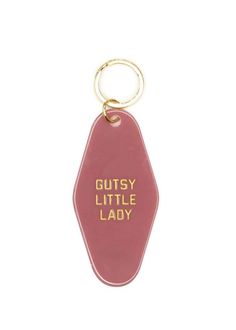 a red keychain with the words gutsy little lady printed on it's side