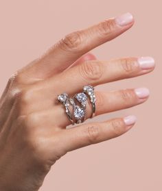 a woman's hand with three rings on it