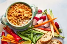 a plate with bread, carrots, celery and other vegetables on it