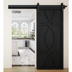 an open door leading to a kitchen with white cabinets