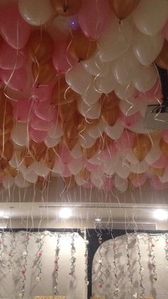 the ceiling is decorated with balloons and streamers