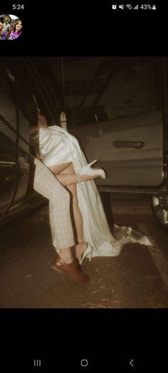 a woman in high heels leaning against the back of a car