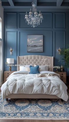 a bedroom with blue walls and a chandelier hanging from the ceiling above the bed