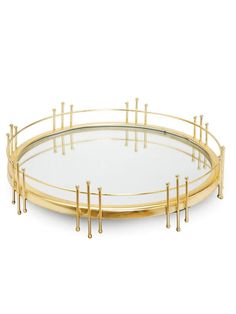 a round glass and brass tray with metal bars on the sides, set against a white background